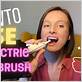 girl uses electric toothbrush