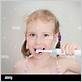 little girl faking electric toothbrush