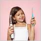 little girl mimics electric toothbrush